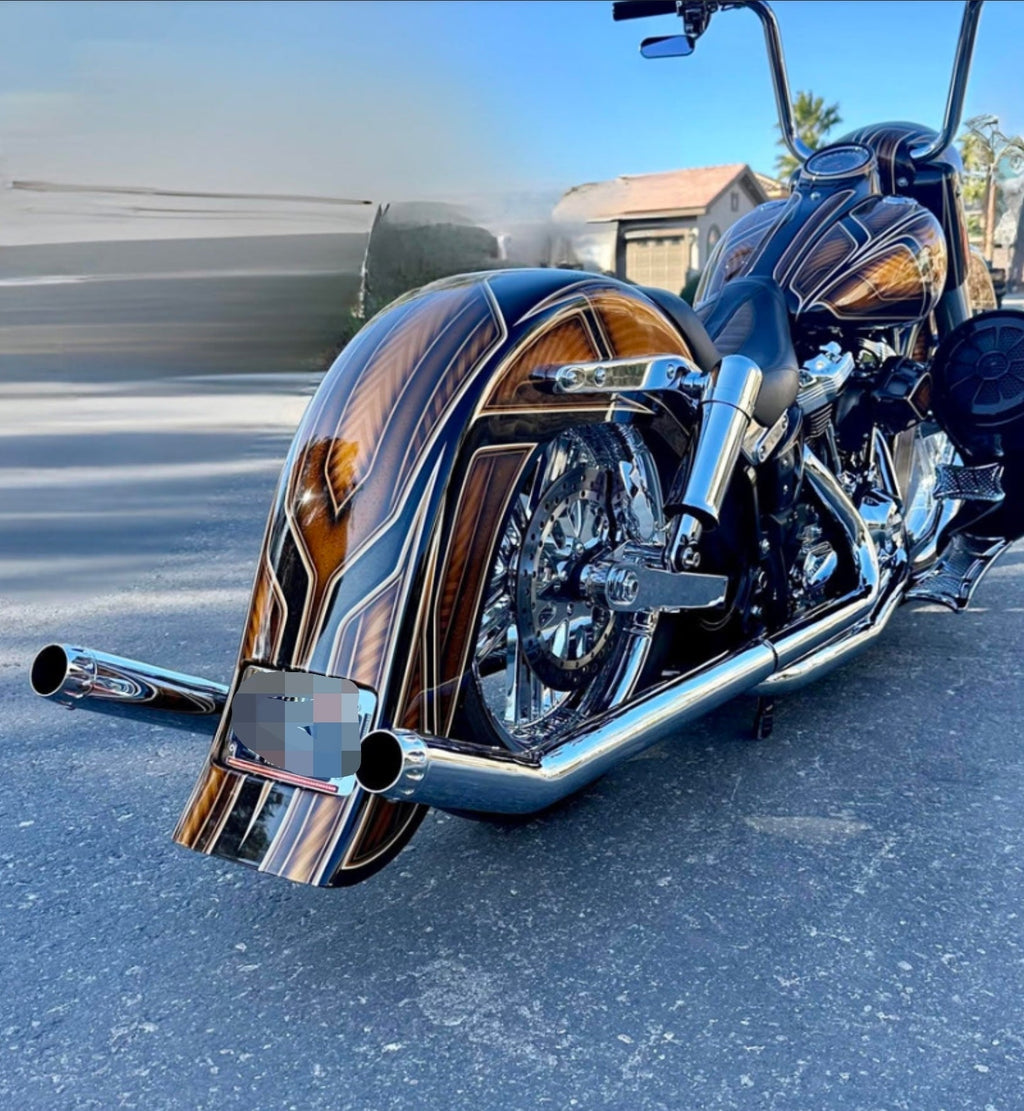 Close-up of chrome shotgun exhaust tip installed on Harley Softail. Available exclusively thru Lawless Custom Cycles