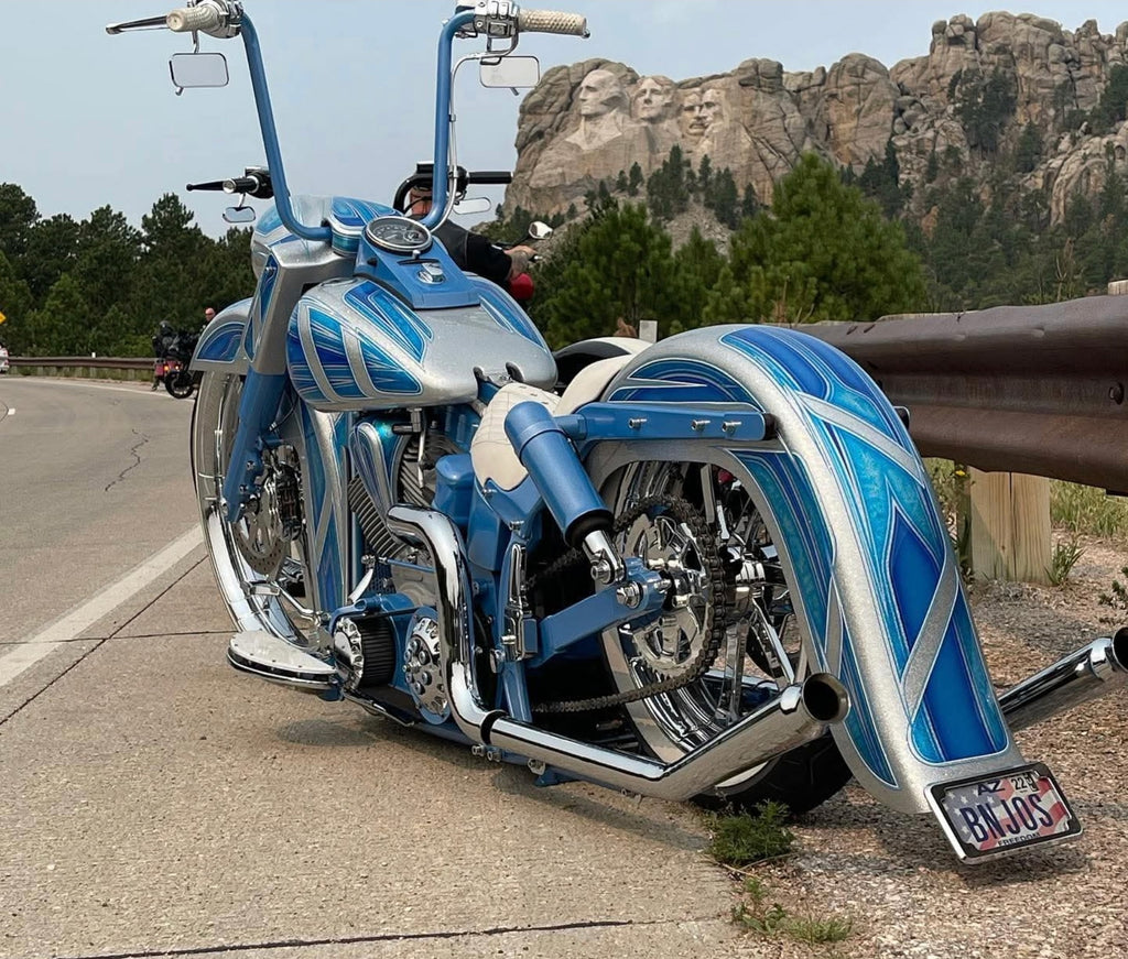 Rear three-quarter view of custom Harley Softail with trumpet upsweep exhaust. Available exclusively thru Lawless Custom Cycles