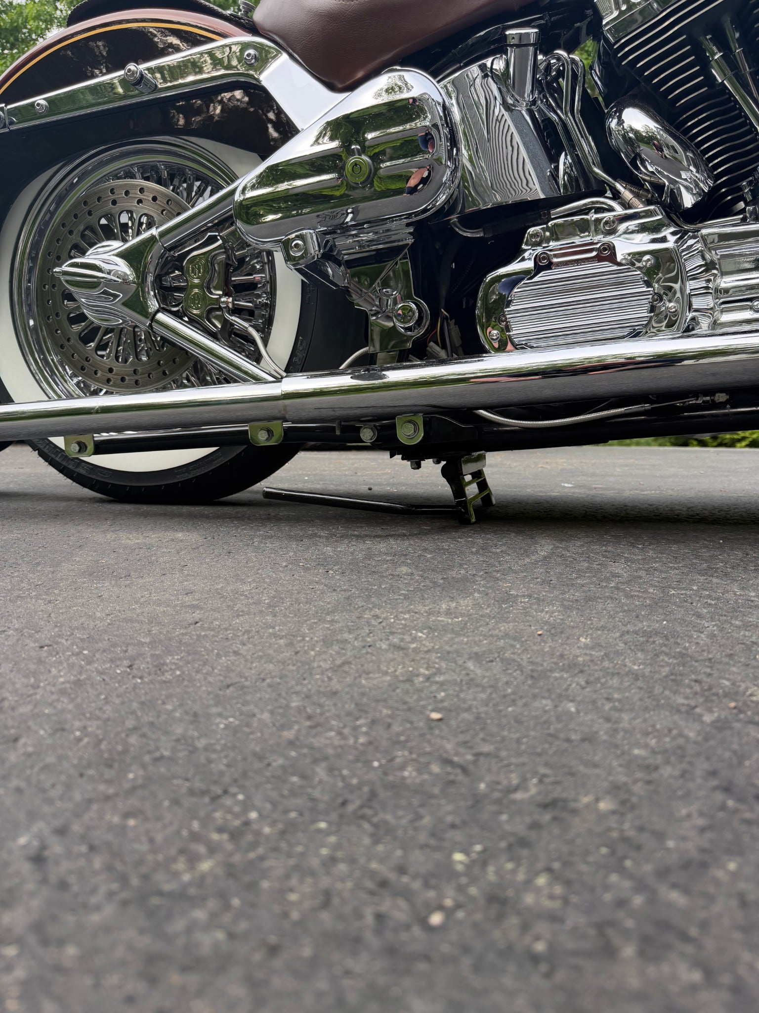 Harley Softail equipped with a LawlessCC hand-built center stand, installed with arm on the right