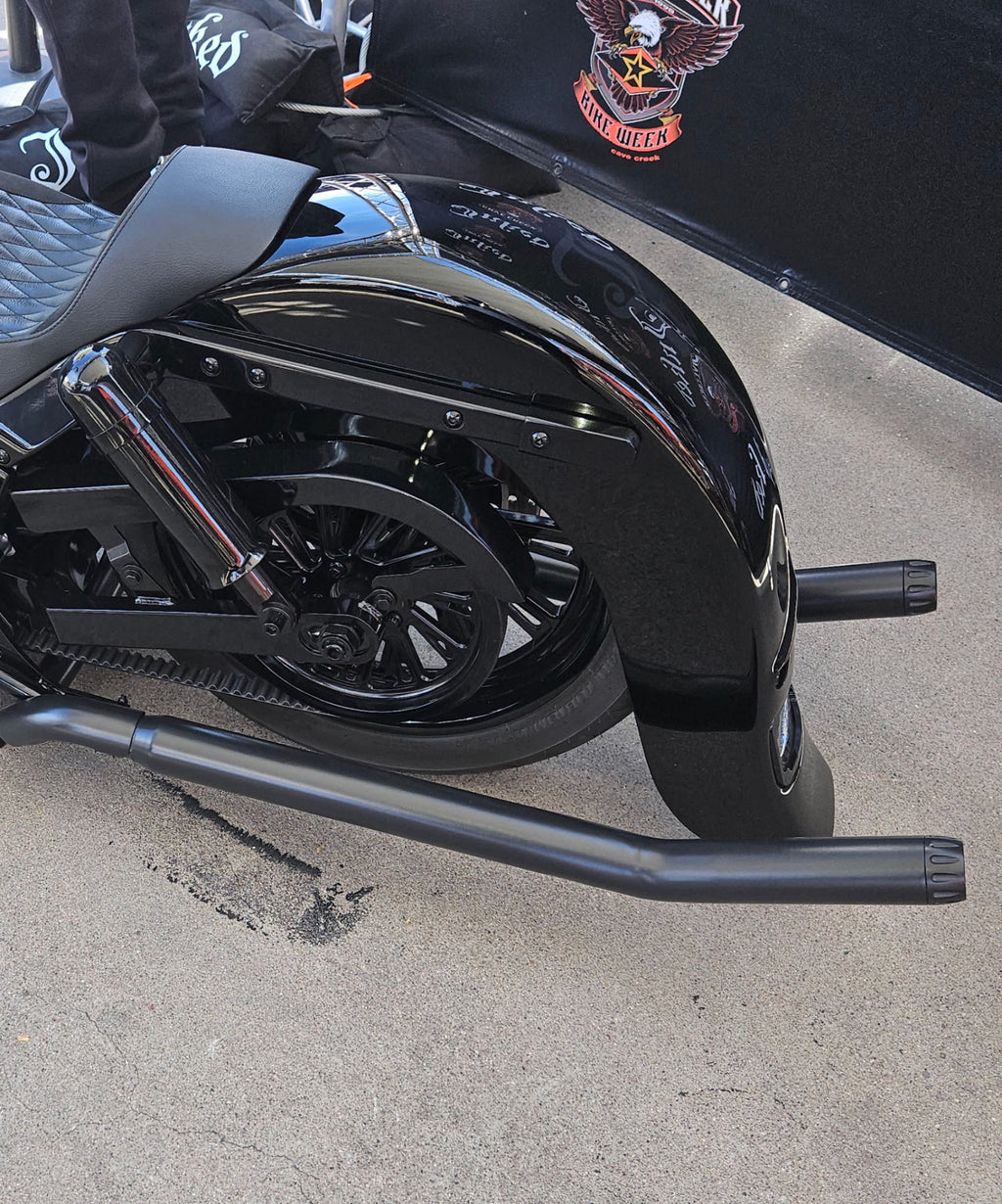 Side view showing black shotgun upswept exhaust installed on Harley Softail. Available exclusively thru Lawless Custom Cycles