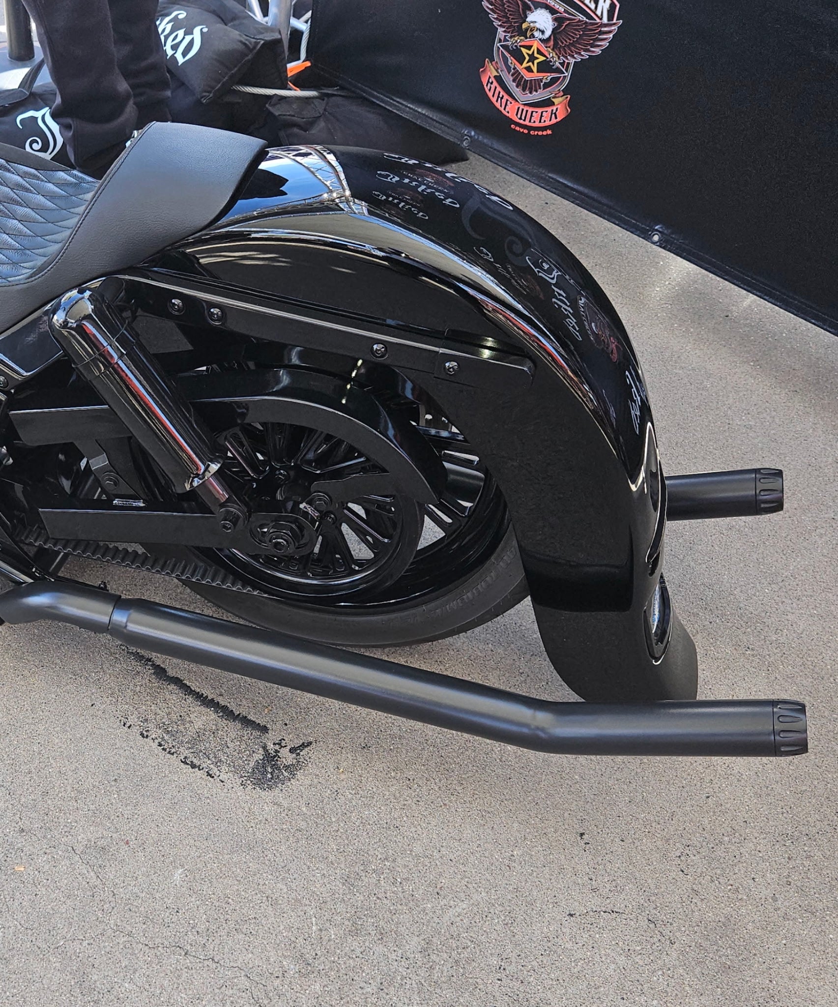 Side view showing black shotgun upswept exhaust installed on Harley Softail. Available exclusively thru Lawless Custom Cycles